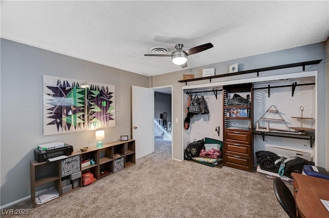 interior space featuring ceiling fan and a textured ceiling