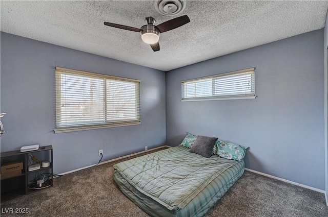 carpeted bedroom with a textured ceiling and ceiling fan