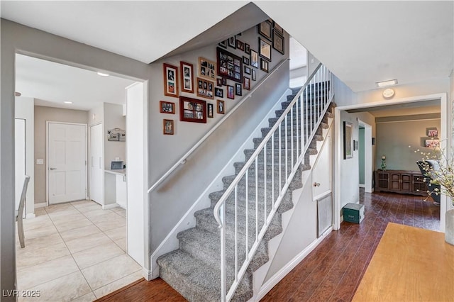 stairway with hardwood / wood-style flooring