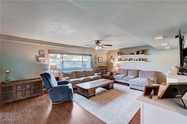 living room featuring hardwood / wood-style floors and ceiling fan