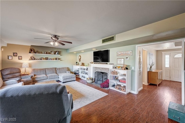 living room with dark wood-type flooring and ceiling fan