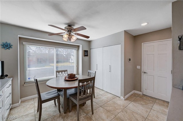 tiled dining space with ceiling fan