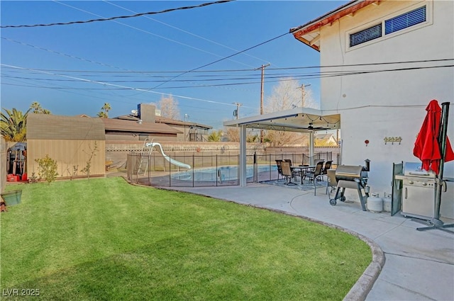 view of yard with a shed and a patio area