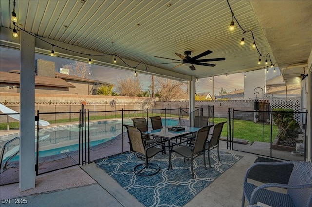 view of patio featuring ceiling fan and a fenced in pool