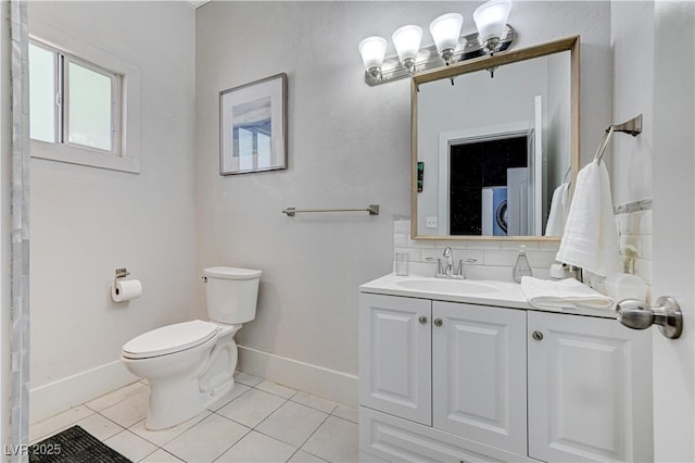 bathroom featuring vanity, backsplash, tile patterned floors, and toilet