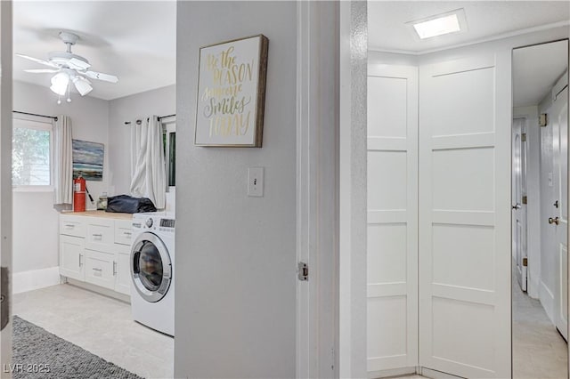 laundry area featuring cabinets, washer / dryer, and ceiling fan