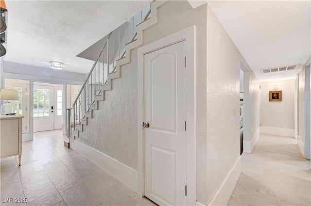 corridor featuring a textured ceiling