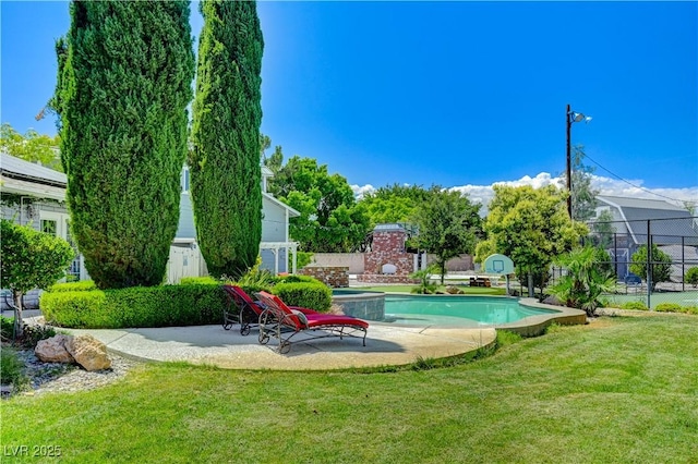 view of swimming pool featuring a patio and a lawn