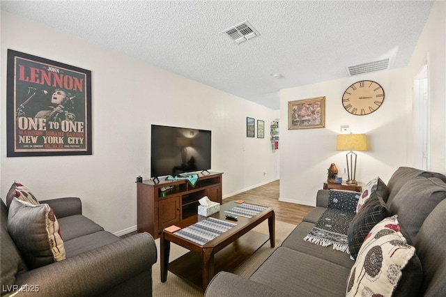 living room featuring hardwood / wood-style floors and a textured ceiling