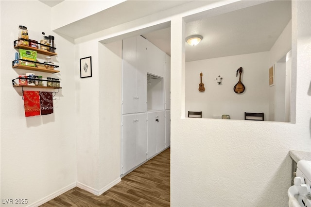 corridor featuring dark hardwood / wood-style floors