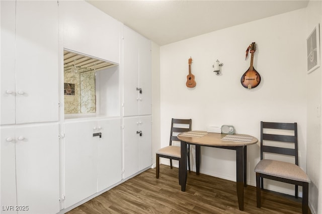 dining space with dark hardwood / wood-style flooring