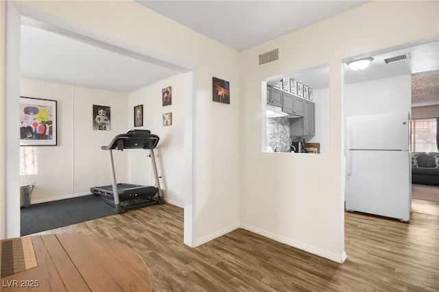 workout area featuring hardwood / wood-style flooring