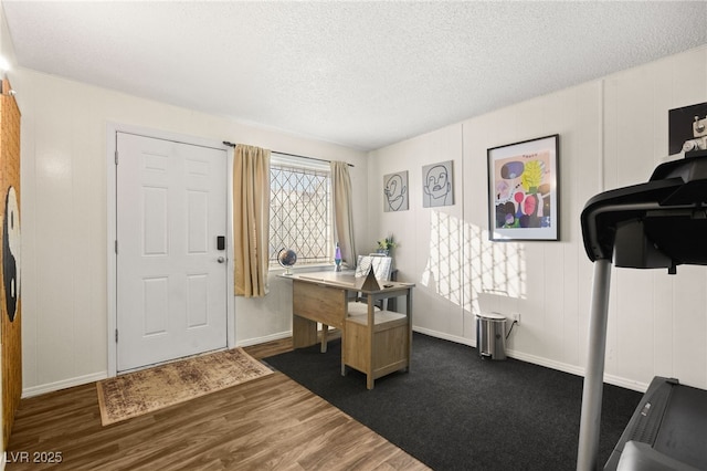 office area with dark hardwood / wood-style flooring and a textured ceiling