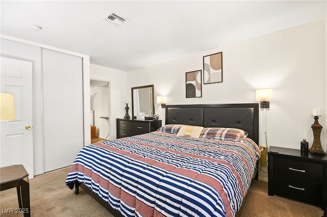 bedroom featuring a closet and dark colored carpet