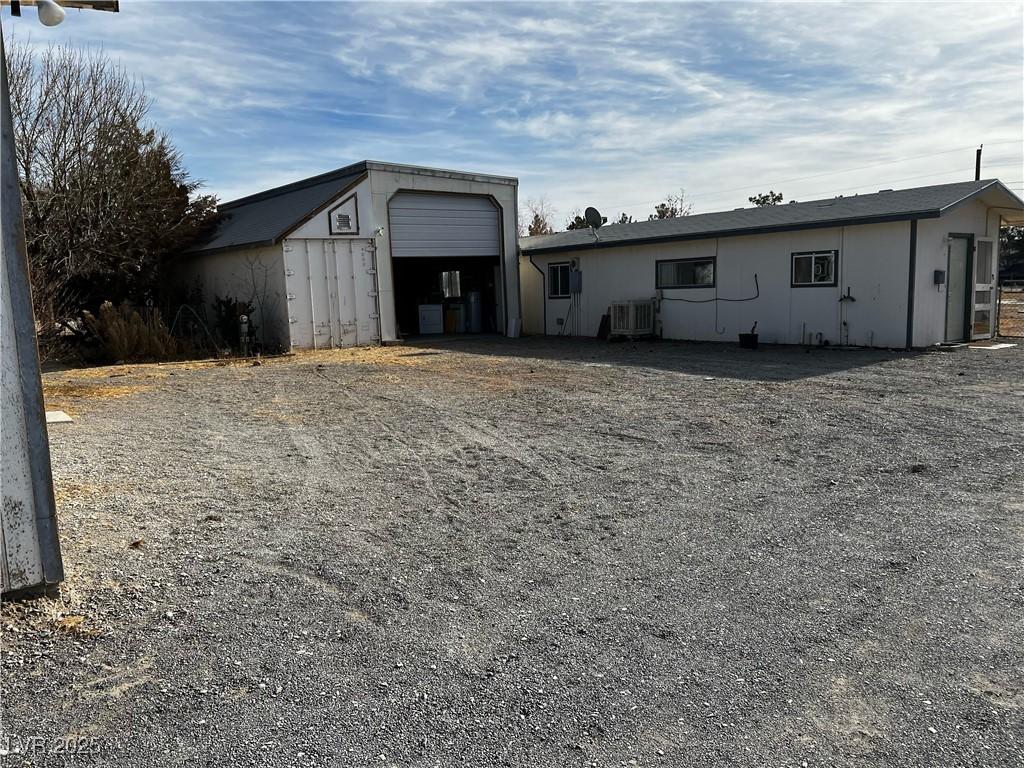 exterior space featuring cooling unit and a garage