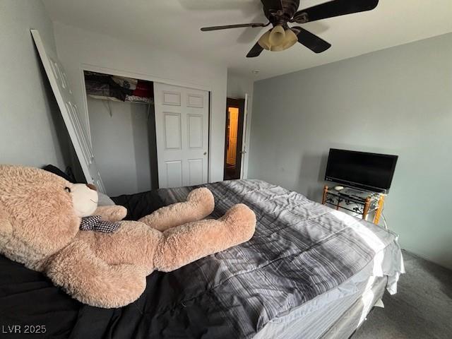 bedroom featuring ceiling fan, a closet, and carpet flooring