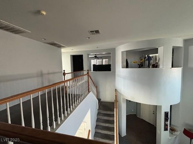 stairway featuring visible vents and ceiling fan