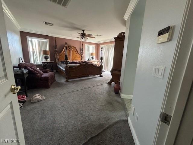 bedroom featuring ornamental molding, carpet, visible vents, and baseboards