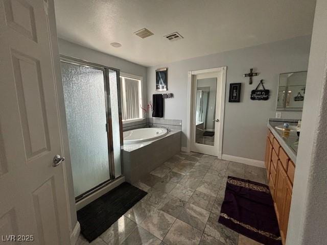 full bath with a garden tub, vanity, visible vents, baseboards, and a shower stall