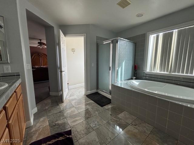 ensuite bathroom with a garden tub, connected bathroom, vanity, visible vents, and a stall shower