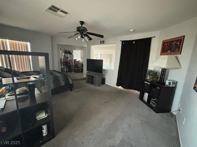 carpeted living area with a ceiling fan and visible vents