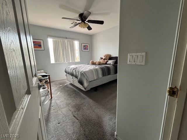 bedroom featuring ceiling fan and carpet