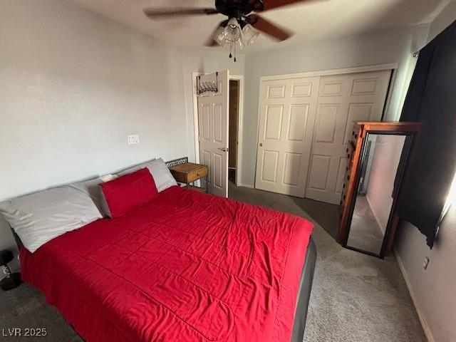 carpeted bedroom with ceiling fan, a closet, and baseboards