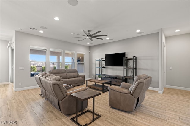 living room with light hardwood / wood-style floors and ceiling fan