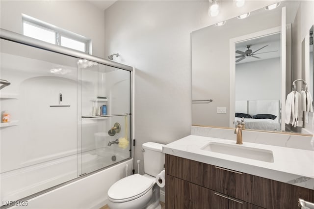 full bathroom featuring vanity, shower / bath combination with glass door, and toilet