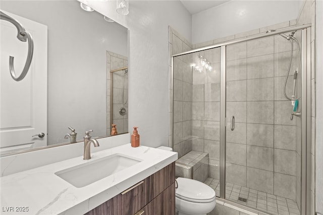 bathroom featuring walk in shower, vanity, and toilet