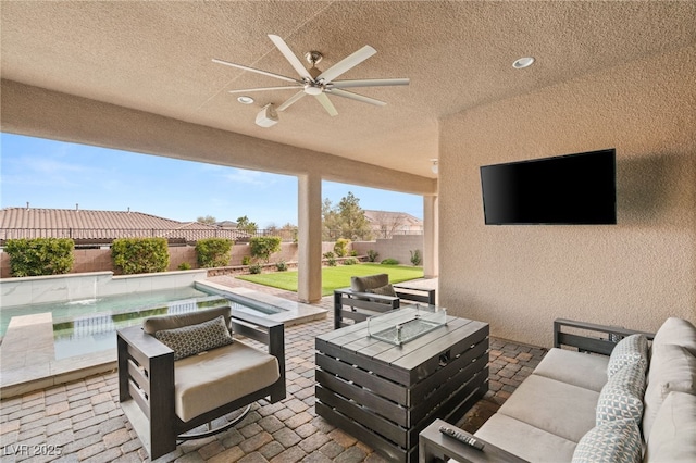 view of patio / terrace with an outdoor living space, ceiling fan, and a pool with hot tub