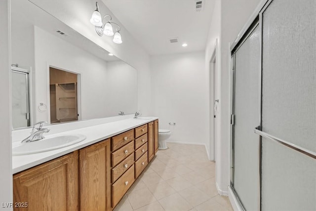 bathroom featuring vanity, an enclosed shower, tile patterned floors, and toilet