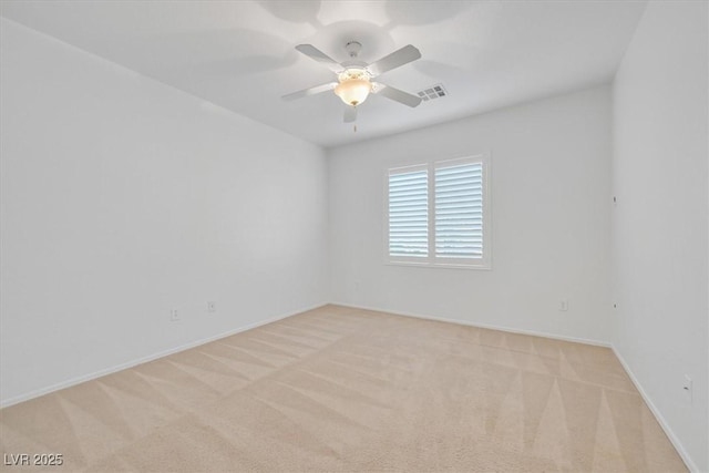 empty room featuring light colored carpet and ceiling fan