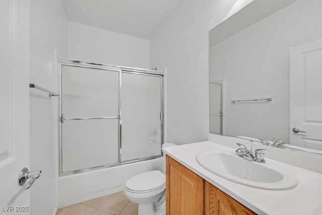 full bathroom featuring vanity, toilet, tile patterned flooring, and combined bath / shower with glass door