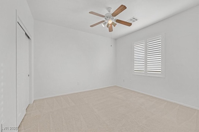 unfurnished room featuring light colored carpet and ceiling fan