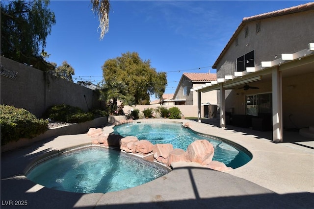 view of pool featuring a patio area, ceiling fan, and an in ground hot tub