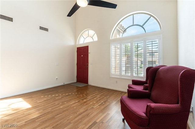 foyer entrance featuring light wood-style flooring, baseboards, and visible vents