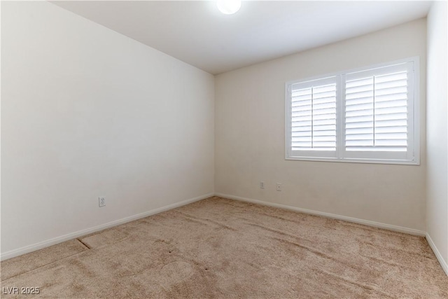 empty room with carpet flooring and baseboards