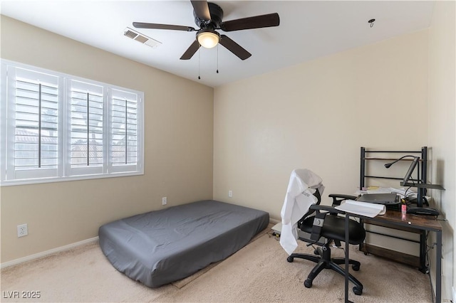 carpeted bedroom featuring a ceiling fan, visible vents, and baseboards