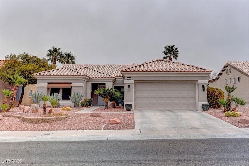 mediterranean / spanish house featuring a garage