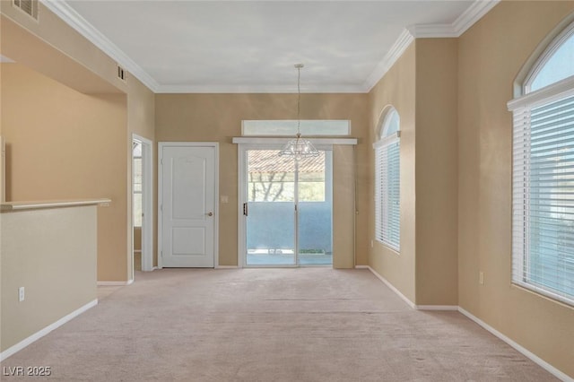 interior space with crown molding, a chandelier, and light carpet