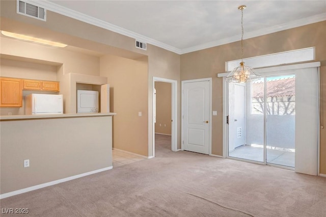 empty room featuring crown molding and light carpet