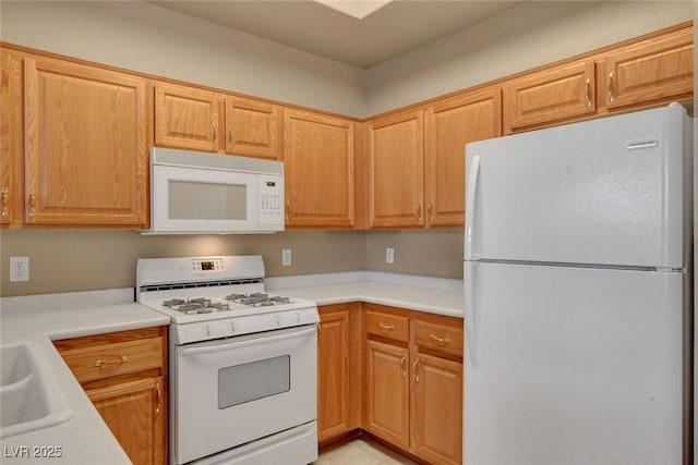 kitchen featuring sink and white appliances