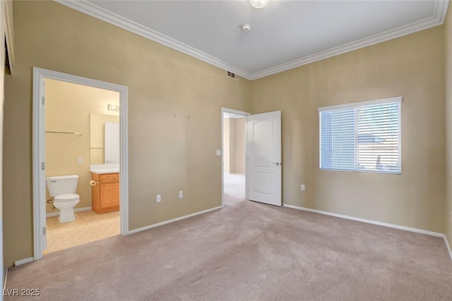 unfurnished bedroom featuring light carpet, crown molding, and ensuite bath