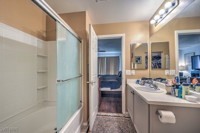 bathroom with vanity and enclosed tub / shower combo