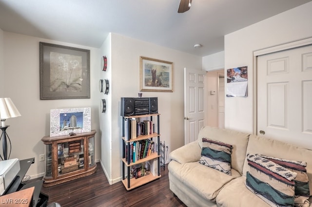 sitting room with ceiling fan and dark hardwood / wood-style flooring