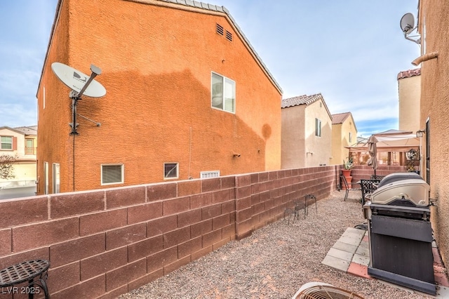 view of side of home with a patio area