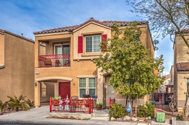 mediterranean / spanish-style house with a balcony