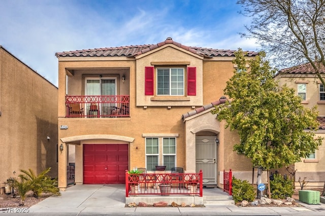 mediterranean / spanish-style house with a garage and a balcony