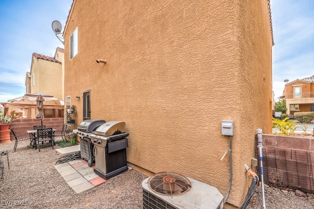 view of side of home featuring a patio and central AC